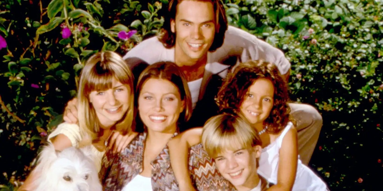 The Camden family of 7th Heaven posing for a photo with their dog
